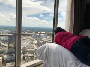 westin peachtree plaza atlanta ga tishia lee on bed looking at birds eye view from the room